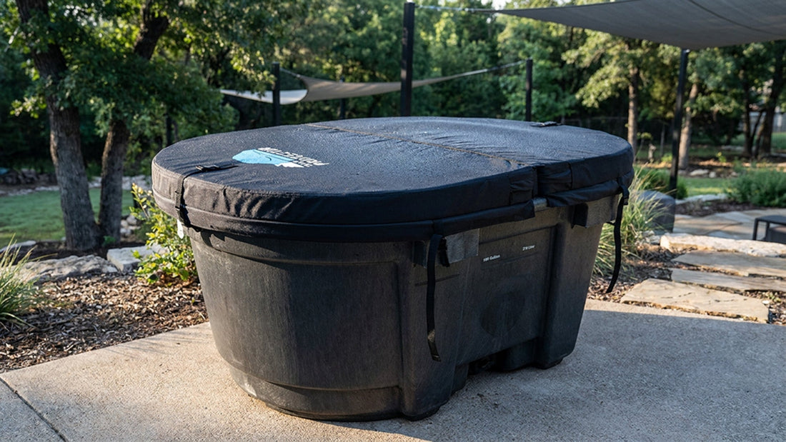 A stock tank cold plunge with an insulated hard foam cover in a well maintained backyard.